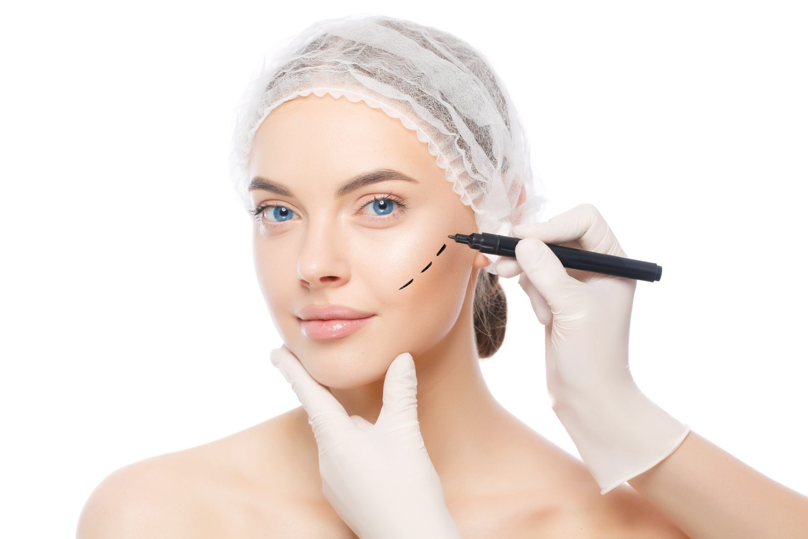 Young beautiful woman prepared for plastic surgery by doctor who uses skin marker, isolated on white background